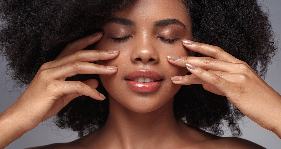 Woman moisturizing her face