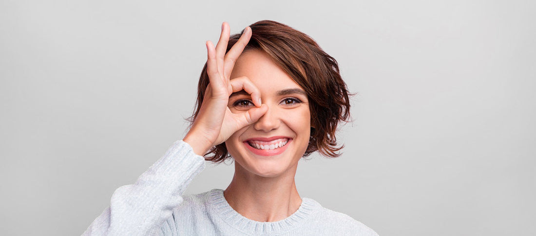 Girl with ok sign in her eye