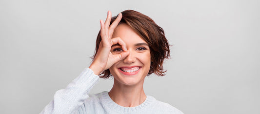 Girl with ok sign in her eye