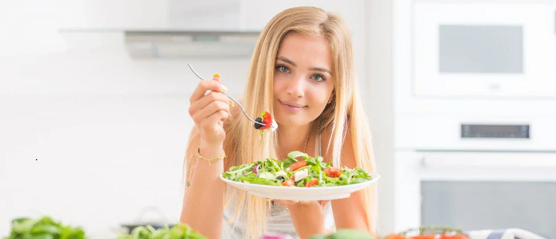 Blonde young girl eating a heathy and balanced food