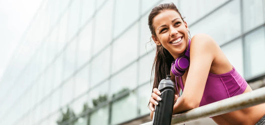 Fitness girl drinks protein after her training