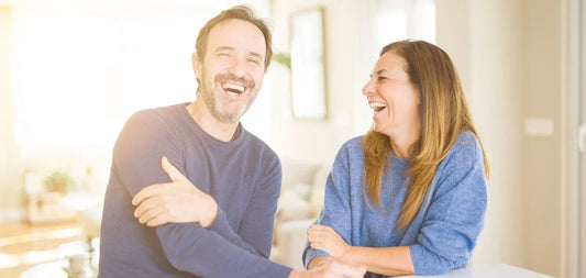 Happy couple in their 50s laughing