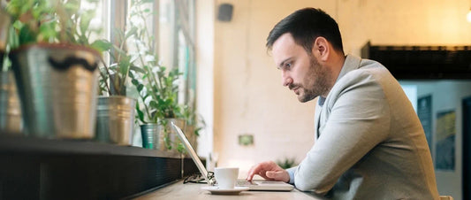 Man concentrating while working on a laptop