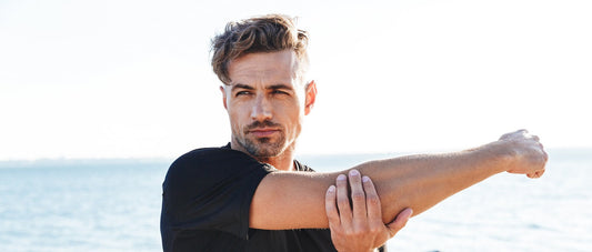 Man stretching arm to recover after the exercise