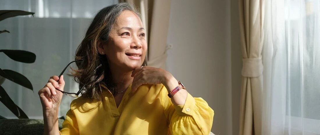 Mature woman relaxing by a sunny window as part of a healthy lifestyle