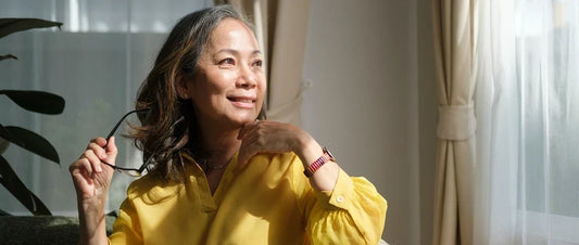 Mature woman relaxing by a sunny window as part of a healthy lifestyle