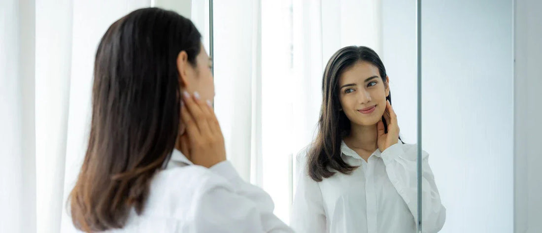 Woman looking herself in a mirror during her morning routine