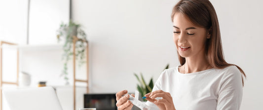 Woman organizing her daily supplements at home
