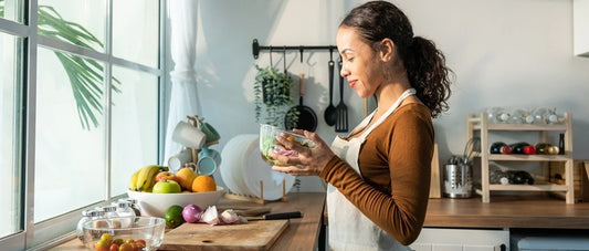 Woman preparing a healthy meal with fresh ingredients at home