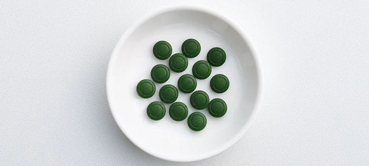 Chlorella tablets on a green dish