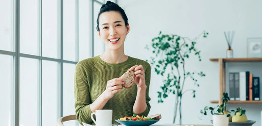 woman enjoying a healthy breakfast as part of a daily wellness routine